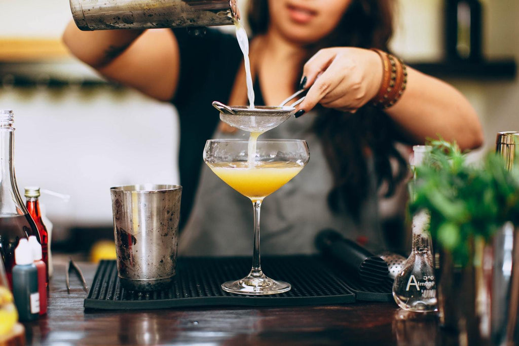 woman making a cocktail 